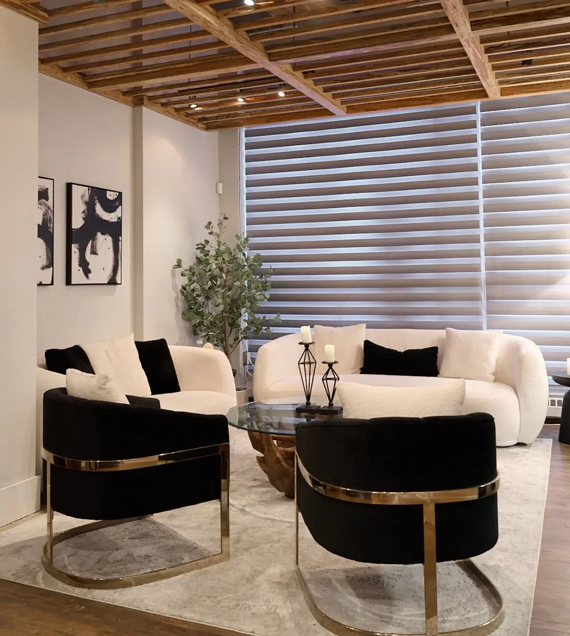 Reception lounge at Leela Eco Spa Beltline — cream sofas, black chairs with gold frames, and a wood-slat ceiling.
