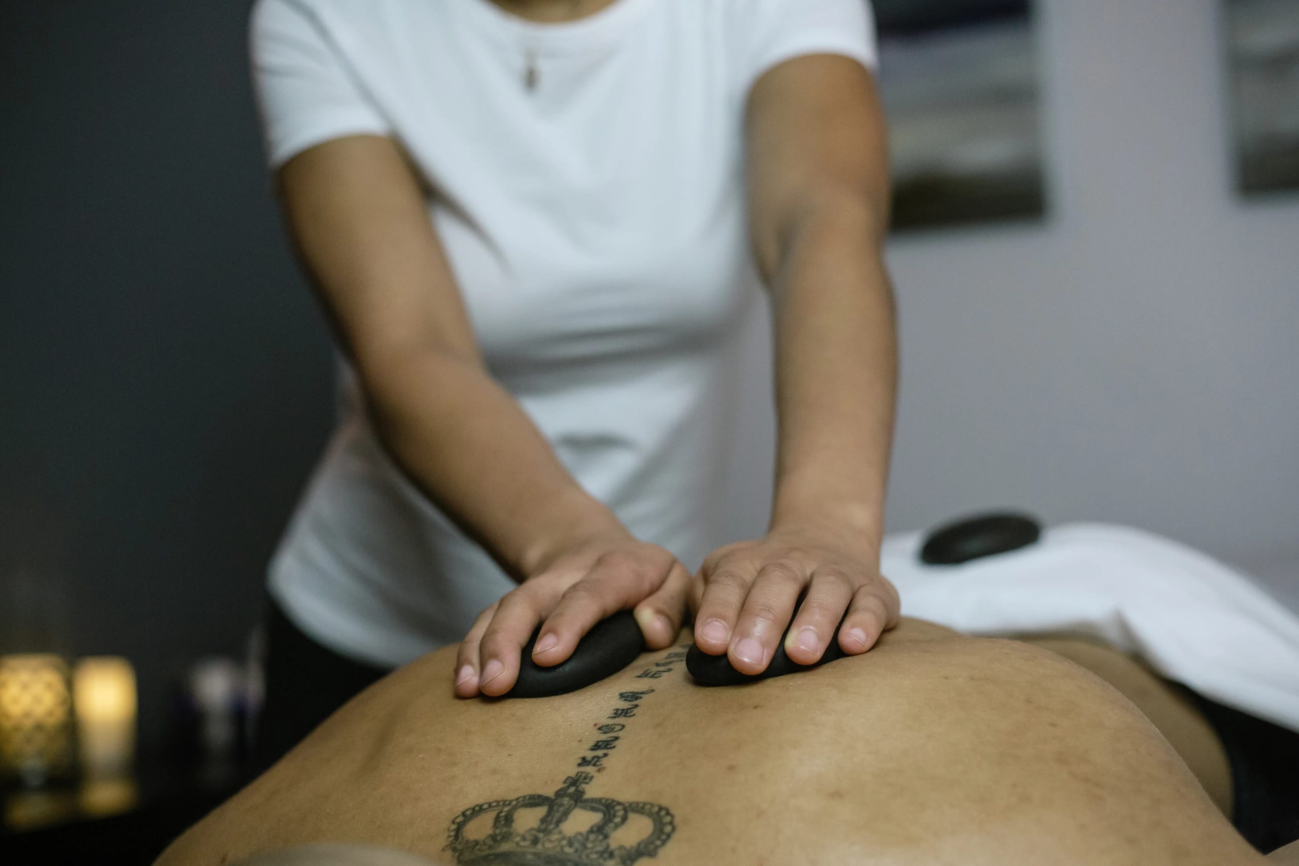 Warm basalt stones resting along the spine during a hot stone massage.