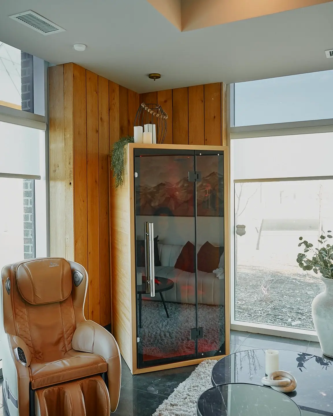 The SALT Booth® at Leela Eco Spa Legacy Township — warm wood cabinetry, glass door, and soft mineral light for dry salt therapy.